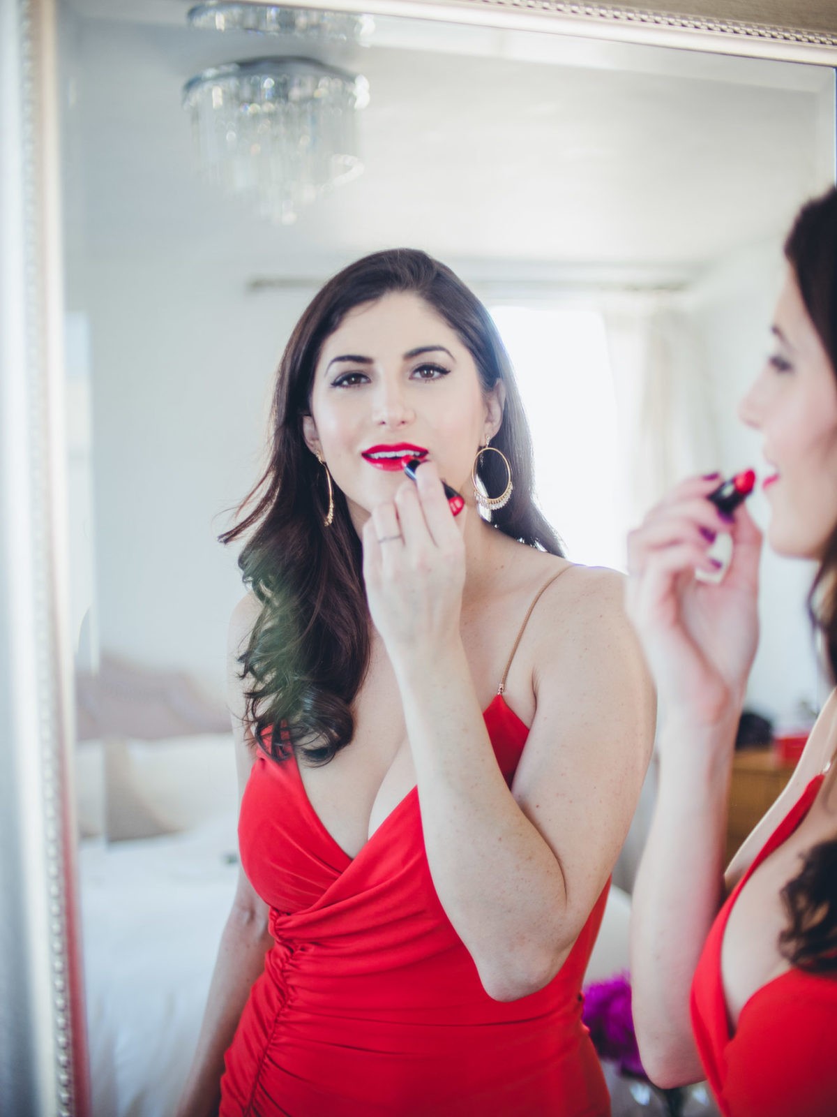 Valentine's Day Outfit featured by top US fashion and beauty blogger Laura Lily: image of a woman wearing an Eliza J red dress, Yves Saint Laurent bag, Stuart Weitzman heels, Chichouz bathrobe, Gorjana earrings, Simone Perele lingerie