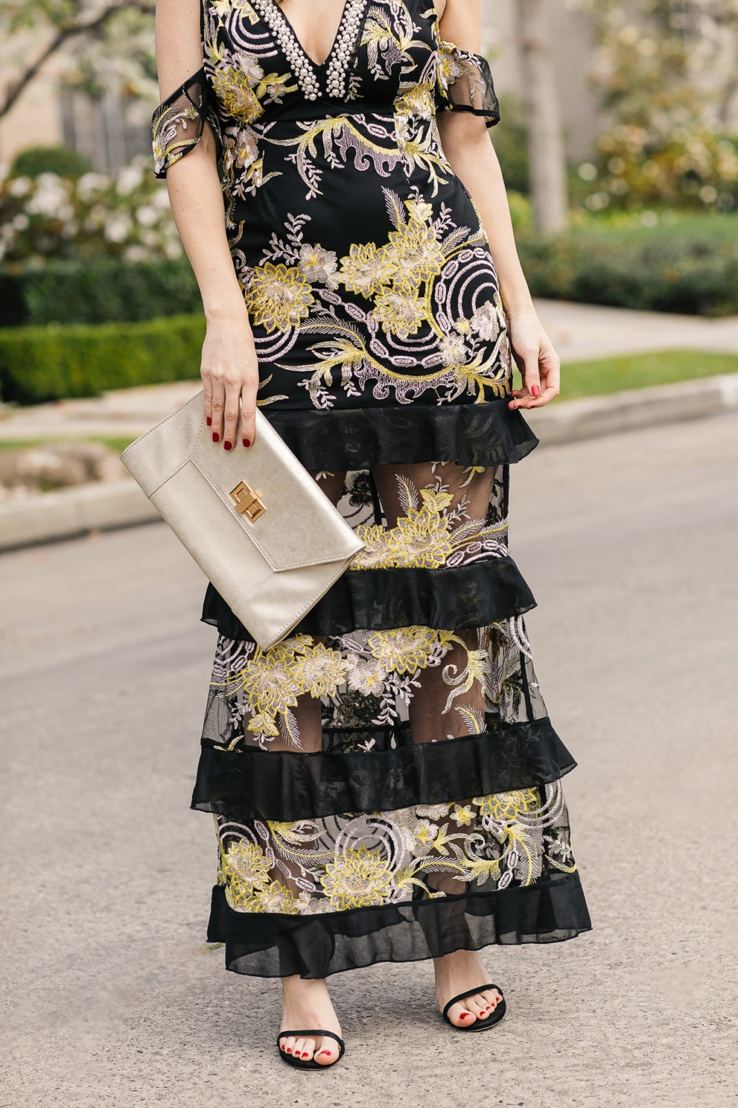 Spring Wedding Outfits featured by top US fashion blogger Laura Lily; Image of a woman wearing an Asos dress, Express clutch, Stuart Weitzman heels and Bauble Bar earrings.