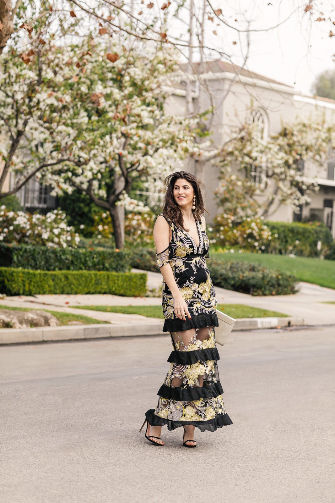 Spring Wedding Outfits featured by top US fashion blogger Laura Lily; Image of a woman wearing an Asos dress, Express clutch, Stuart Weitzman heels and Bauble Bar earrings.
