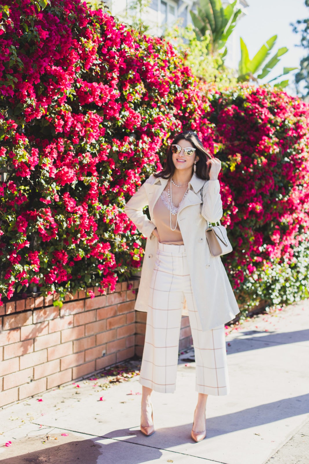 Spring Work Outfits featured by top US fashion blogger Laura Lily; Image of a woman wearing trench coat and Culottes pants.