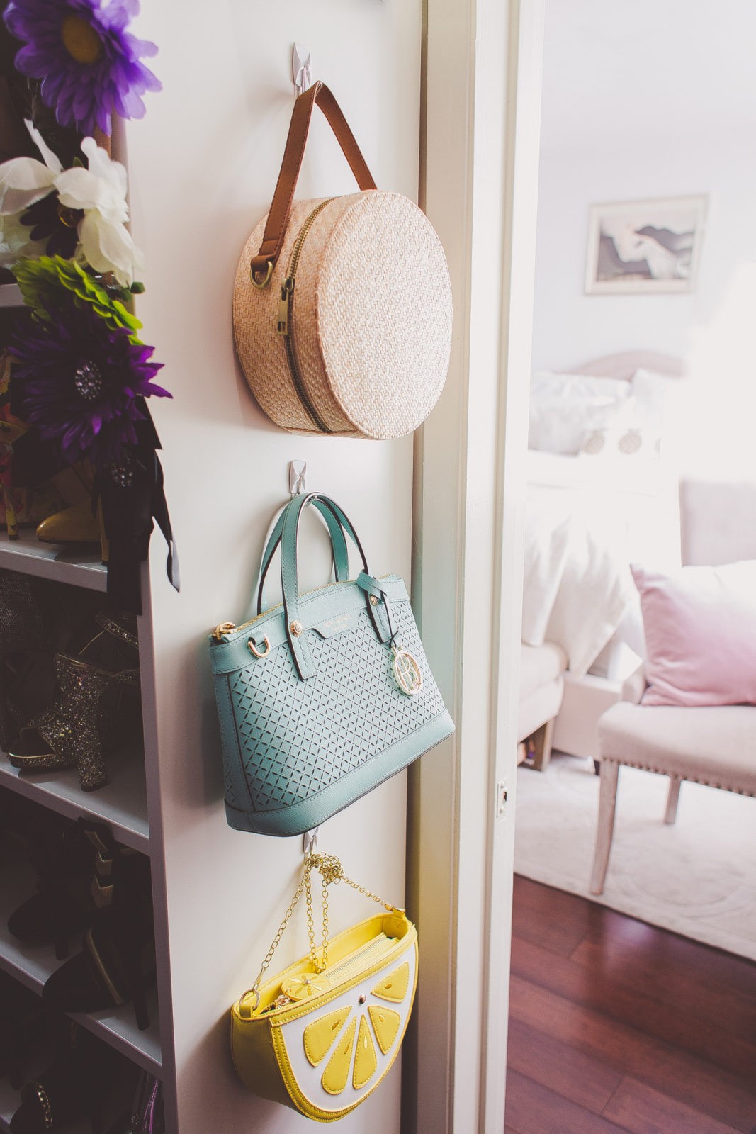 Quick Tips for Tidying Up Your Home,closet organization by Los Angeles Lifestyle Blogger Laura Lily | Tips on Tidying Up Your Home and Shopping Less by popular Los Angeles life and style blogger, Laura Lily: image of three purses hanging on hooks.