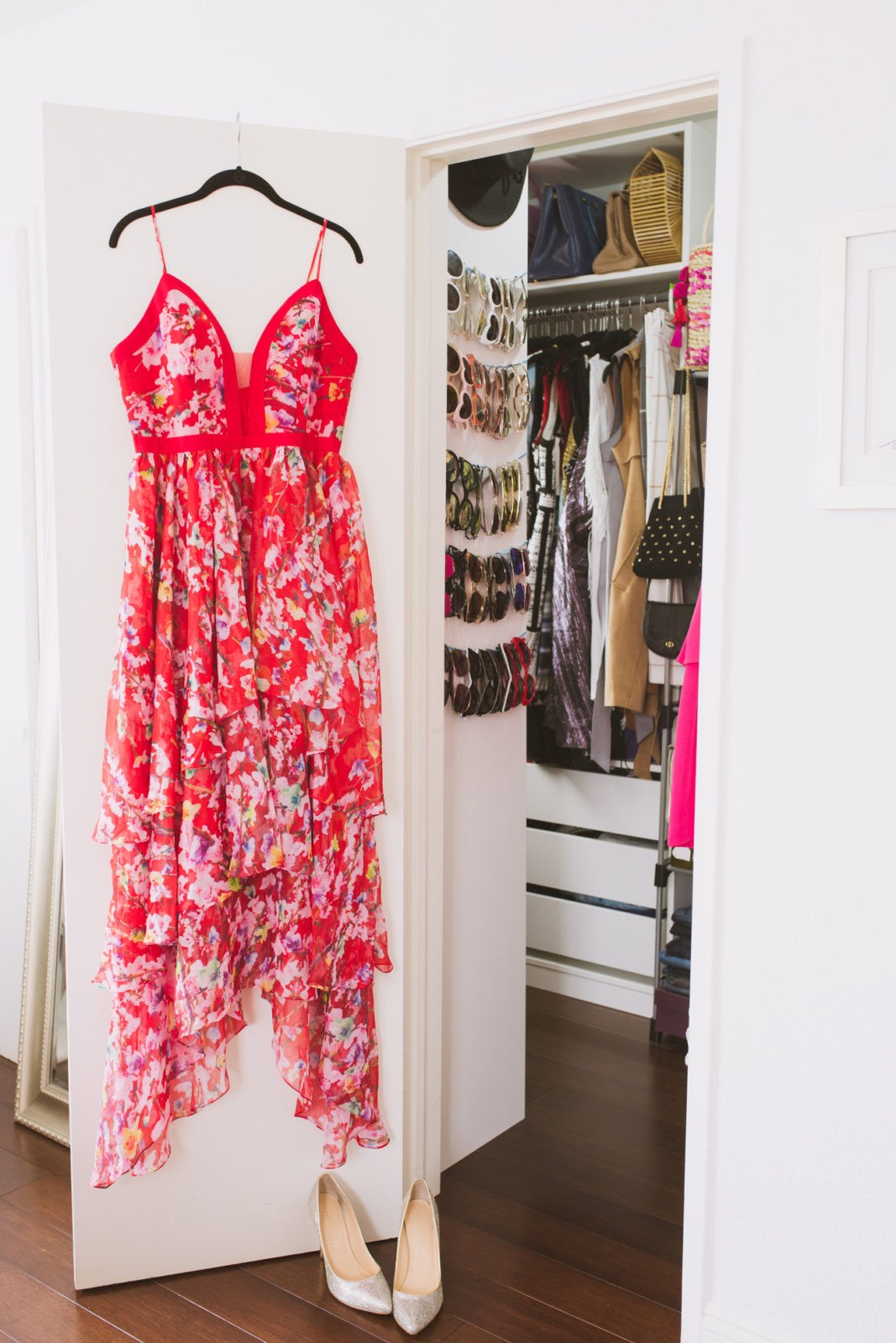 Tips for Tidying Up Your Home and Shopping Less,closet organization by Los Angeles Lifestyle Blogger Laura Lily | 5 Easy Ways to Improve Your Life Right Now by popular Los Angeles life and style blogger Laura Lily: image of a red floral dress hanging on a closet door.