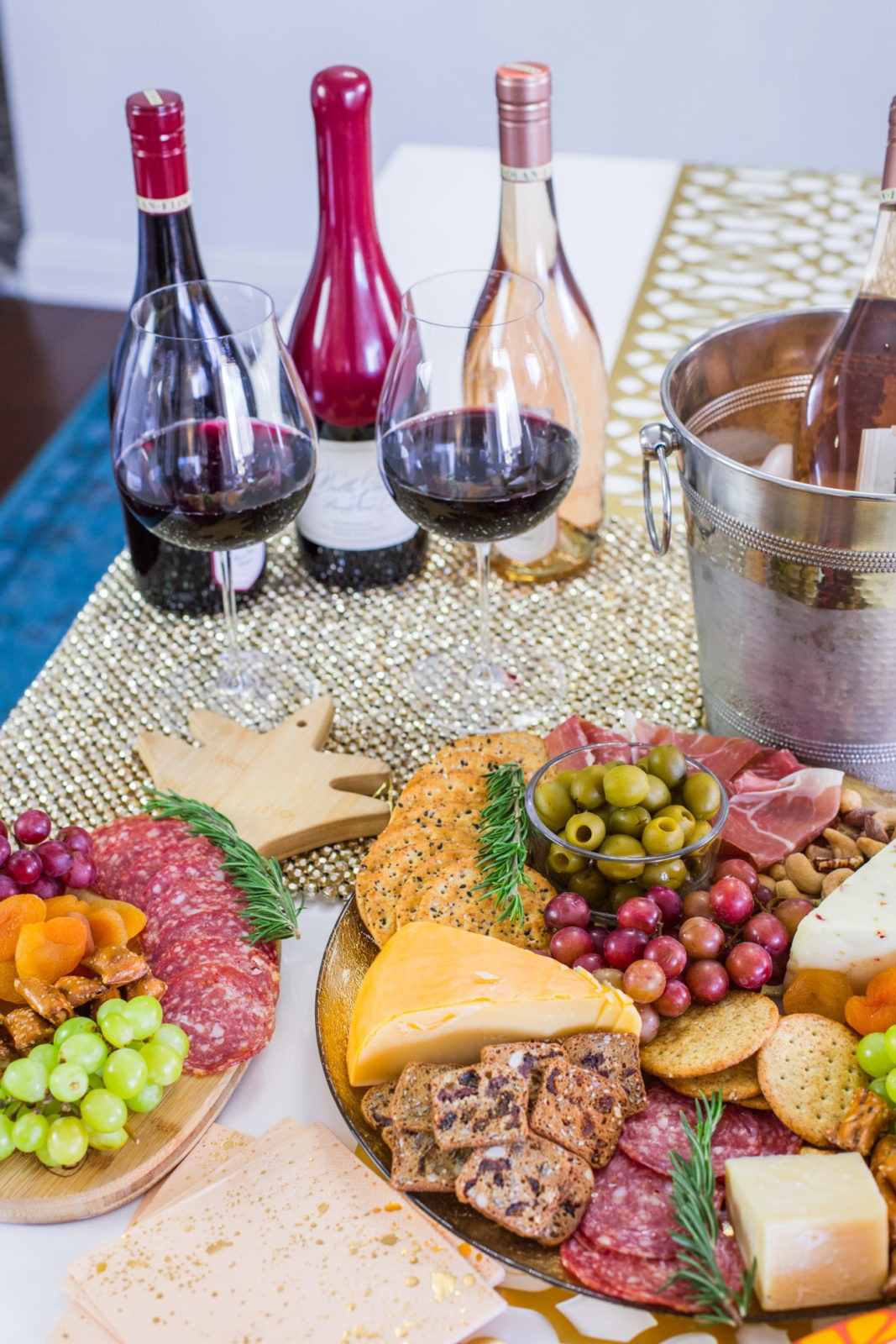 How to Make the best charcuterie board by Popular Lifestyle Blogger Laura Lily | Dinner Party Essentials: Hosting Tips, Table Settings Ideas and Bar Cart Inspiration by popular Los Angeles life and style blogger, Laura Lily: image of charcuterie boards and bottles of red wine. 