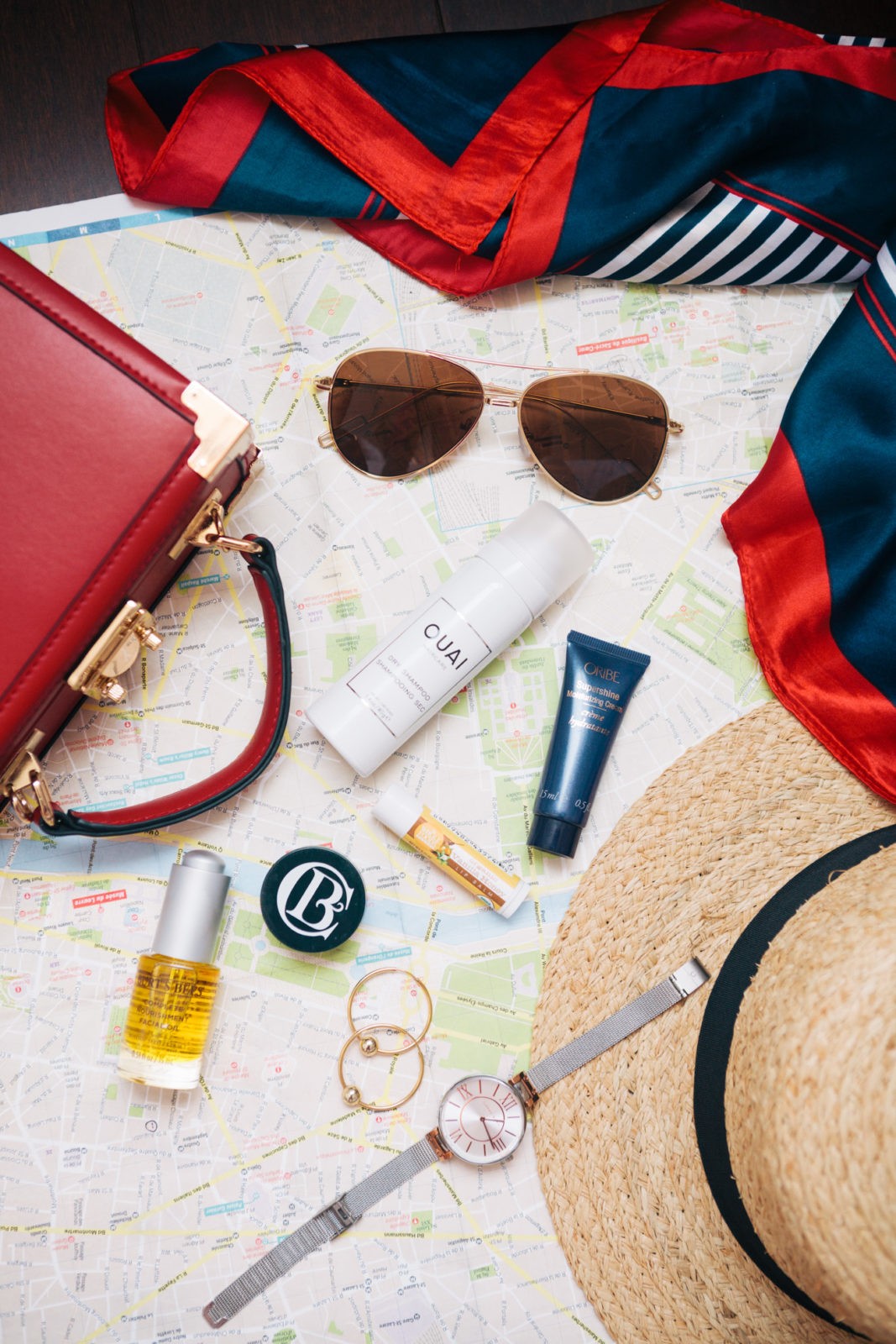 The Travel Size Beauty Products I Never Leave Home Without by Beauty Blogger Laura Lily, Ouai dry shampoo, Burts Bees Complete Nourishment Facial Oil, Clark Botanicals Deep Moisture Mask,