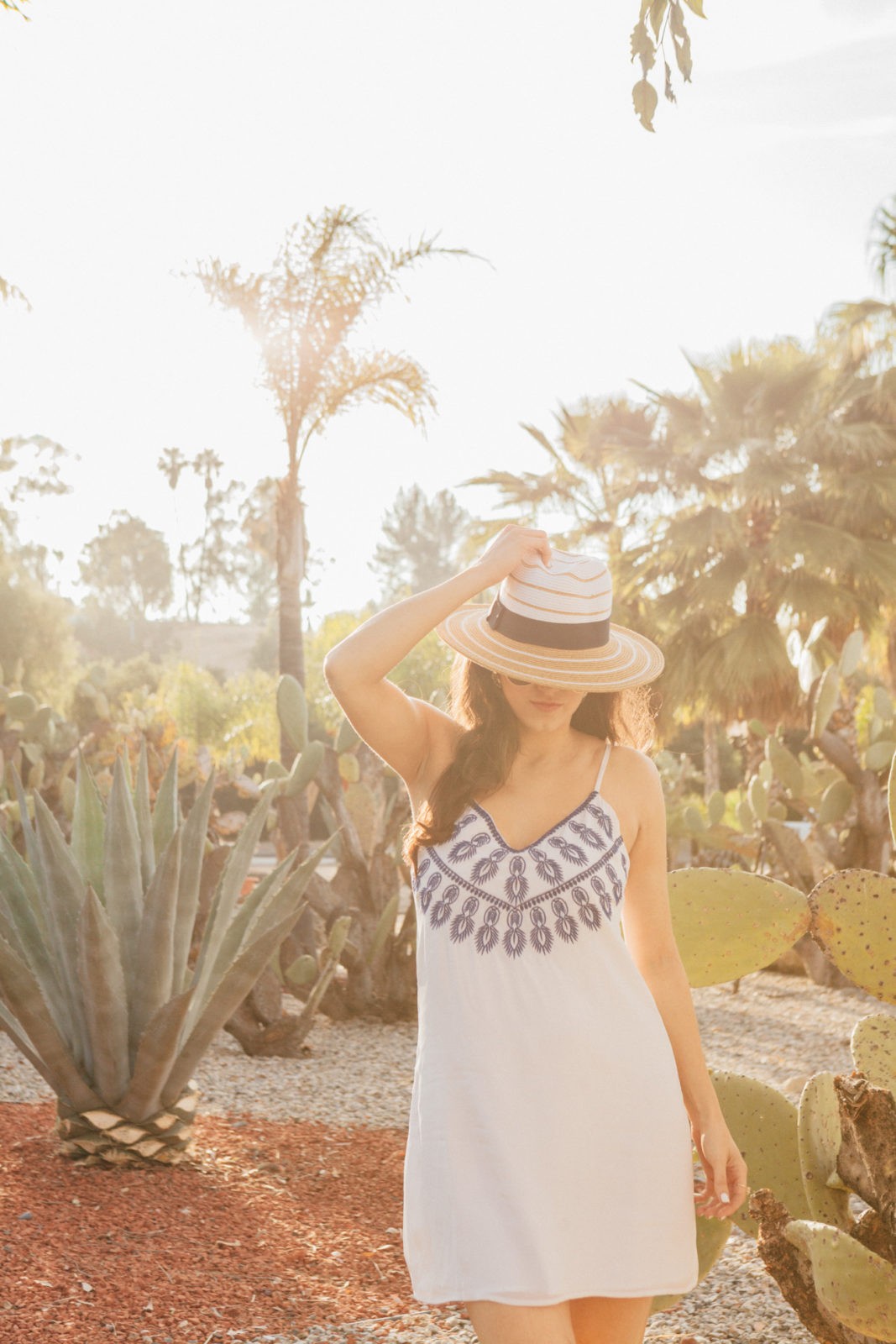 Cabo San Lucas Packing List featured by top US fashion and travel blogger Laura Lily; Image of a woman wearing ASbyDF dress, Forever21 Sunglasses, Lulu’s Sandals and Dynamic Asia Hat.