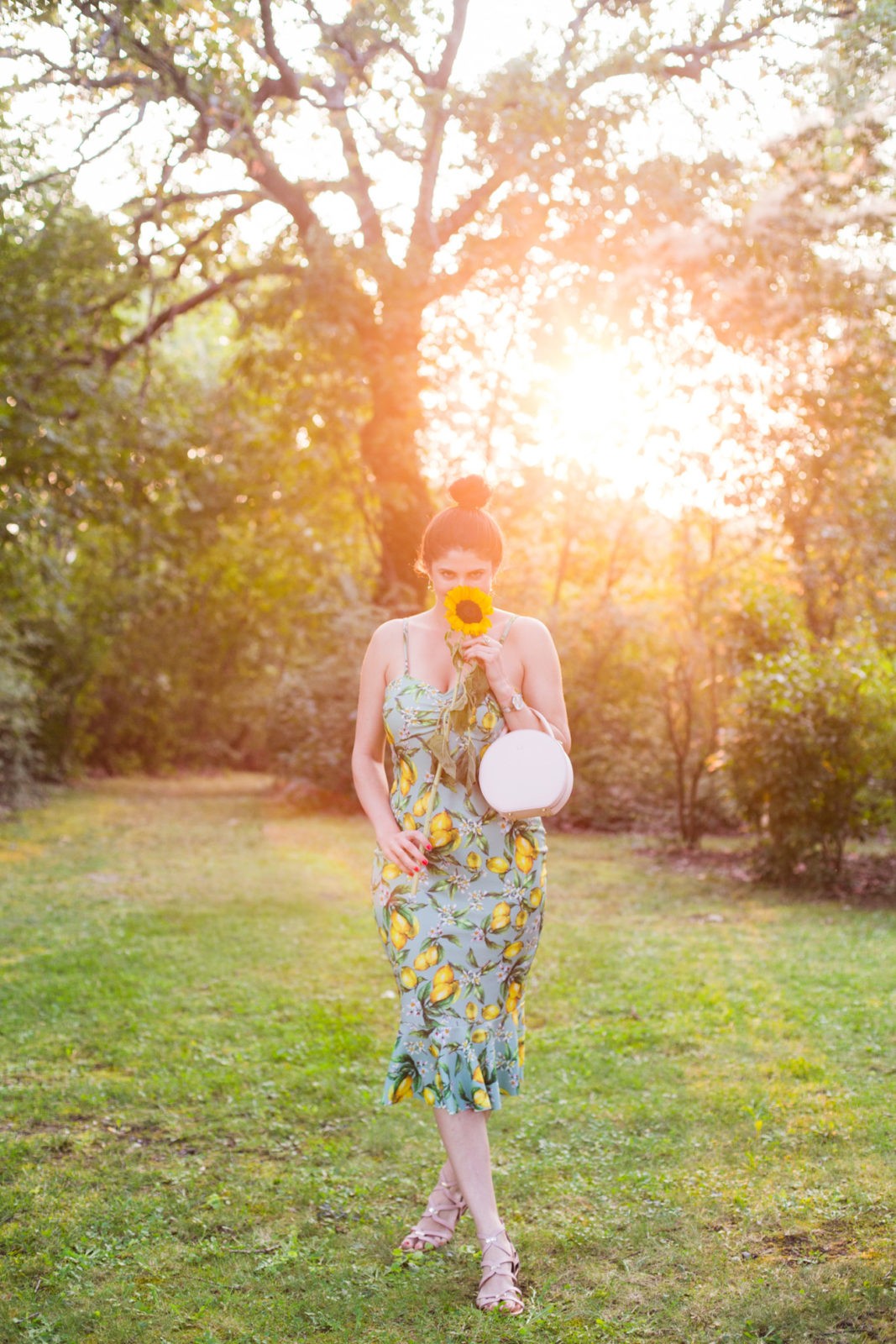 Summer Picnic in Italy by Lifestyle Blogger Laura Lily, I Am Fashion Laine, Elizabeth Keene | Summer Picnic in Italy by Lifestyle Blogger Laura Lily, I Am Fashion Laine, Elizabeth Keene, | An Italian Picnic by popular US fashion blogger, Laura Lilly: image of a woman in a lemon print boohoo dress at La Foce Property in Tuscany, Italy.