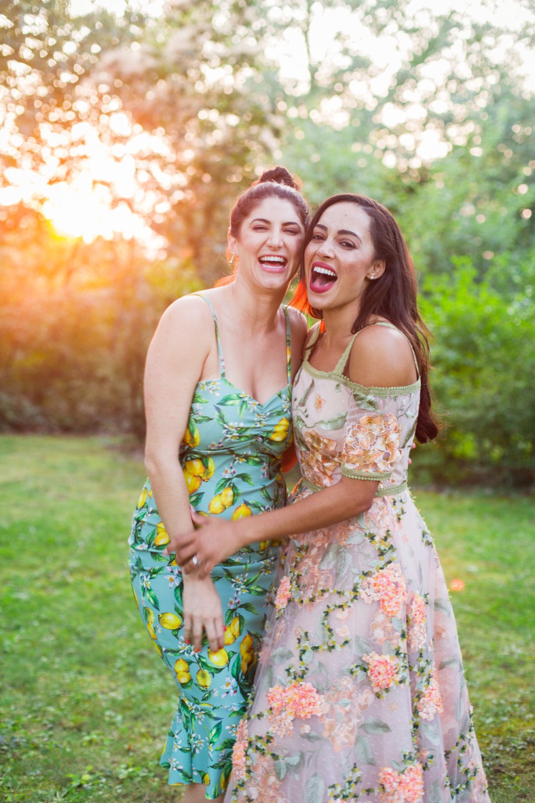 Summer Picnic in Italy by Lifestyle Blogger Laura Lily, I Am Fashion Laine, Elizabeth Keene | An Italian Picnic by popular US fashion blogger, Laura Lilly: image of 2 women in garden dresses standing together with their arms around each other at La Foce Property in Tuscany, Italy.