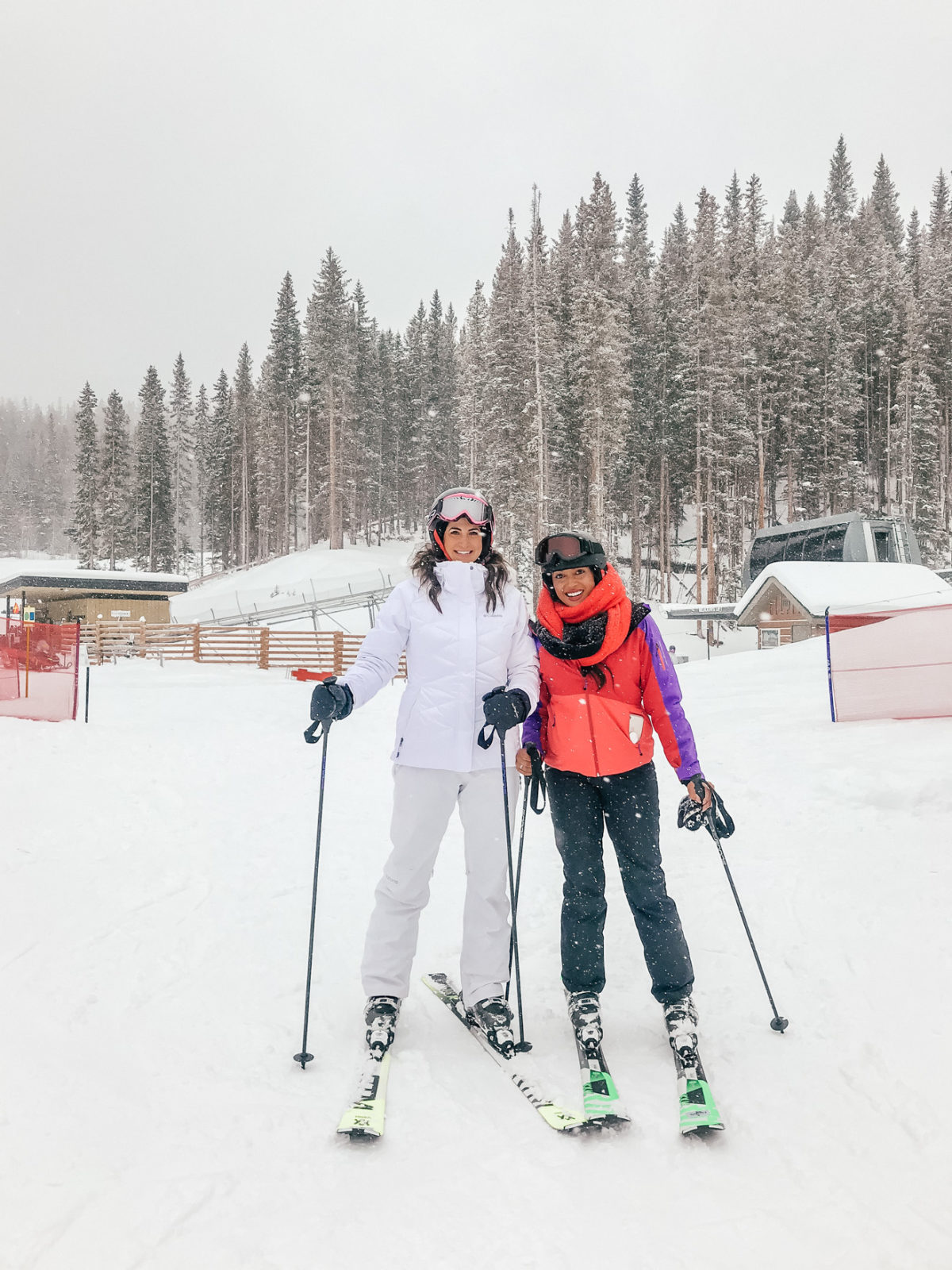 The Best St. Regis Aspen Travel Guide by featured by top Los Angeles Travel Blogger, Laura Lily : image of two women skying on Snowmass mountain