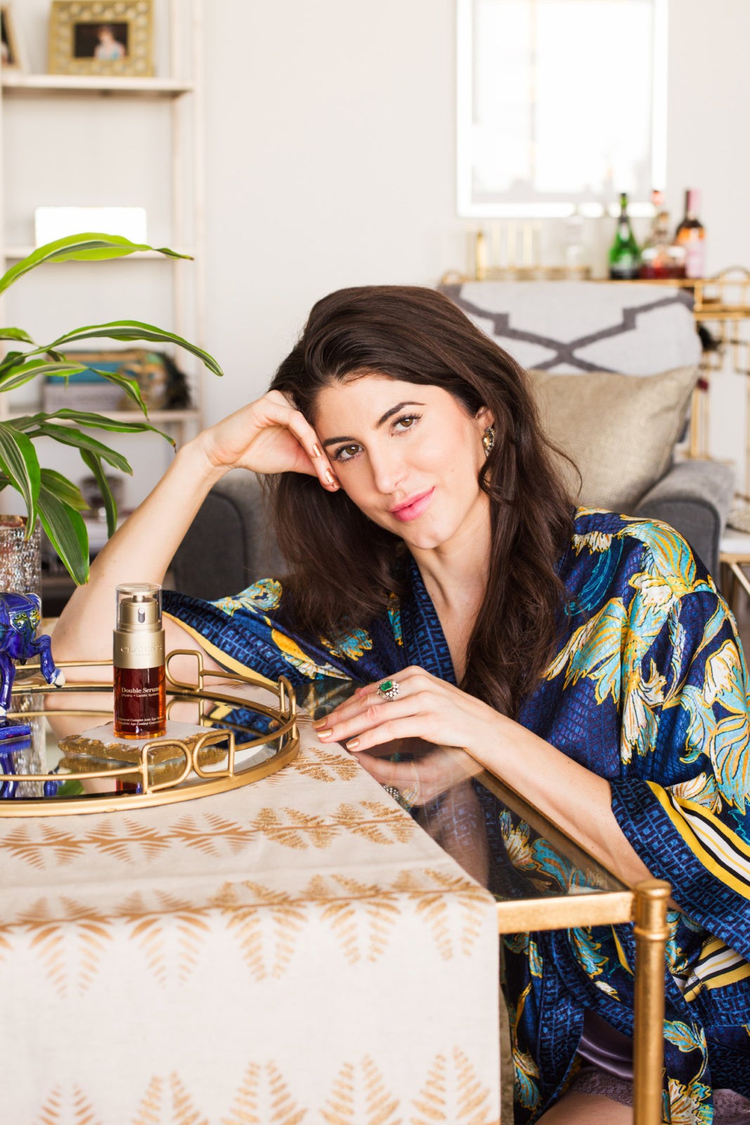 Clarins Double Serum featured by top US fashion blogger Laura Lily; Image of a woman wearing a blue silk robe.