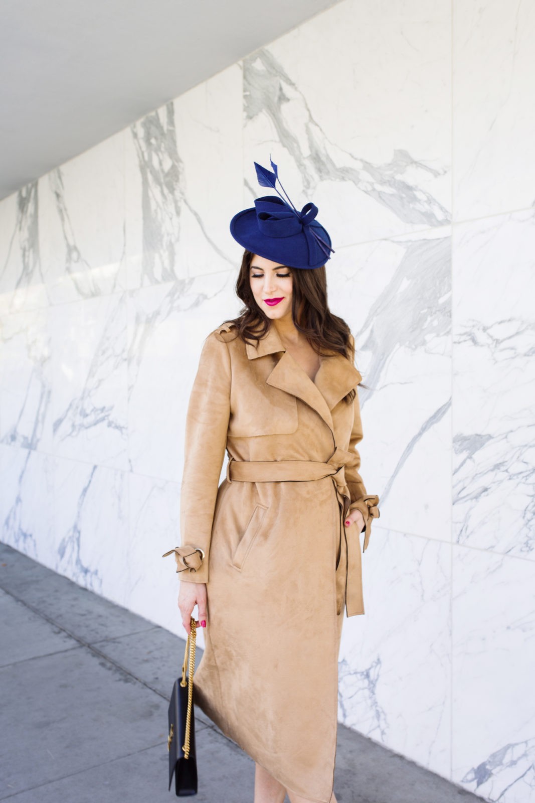 Top US fashion blogger, Laura Lily, features the best fascinators: image of a woman wearing a vintage blue fascinator, River Island trench coat, Yves Saint Laurent shoulder bag, and Schutz heels. | The Marvelous Mrs. Maisel Style, Suede River Island Trench Coat,