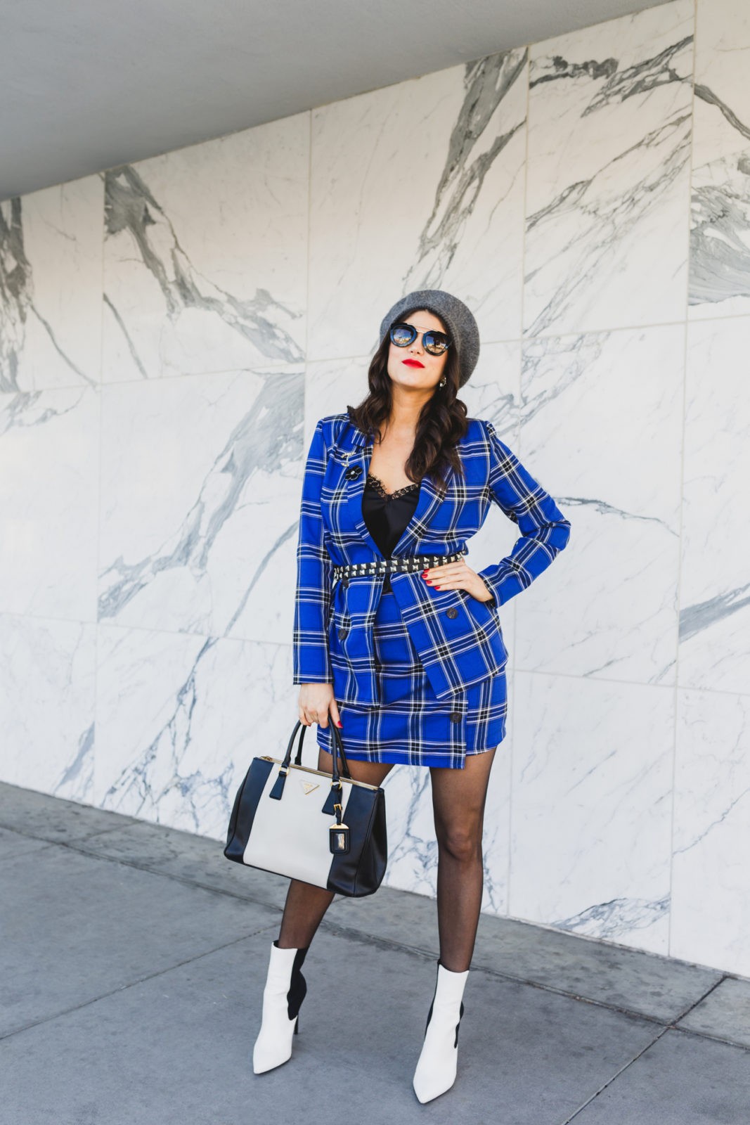 Blue plaid suit style for Spring by top US fashion blogger, Laura Lily: image of a woman wearing an ASOS blue plaid suit, Wolford back seam tights, Dynamic Asia hat, Steve Madden black and white booties, 