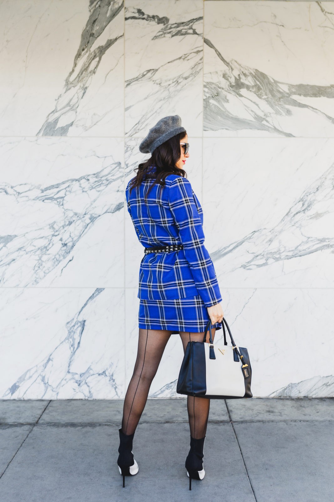 Blue plaid suit style for Spring by top US fashion blogger, Laura Lily: image of a woman wearing an ASOS blue plaid suit, Wolford back seam tights, Dynamic Asia hat, Steve Madden black and white booties,
