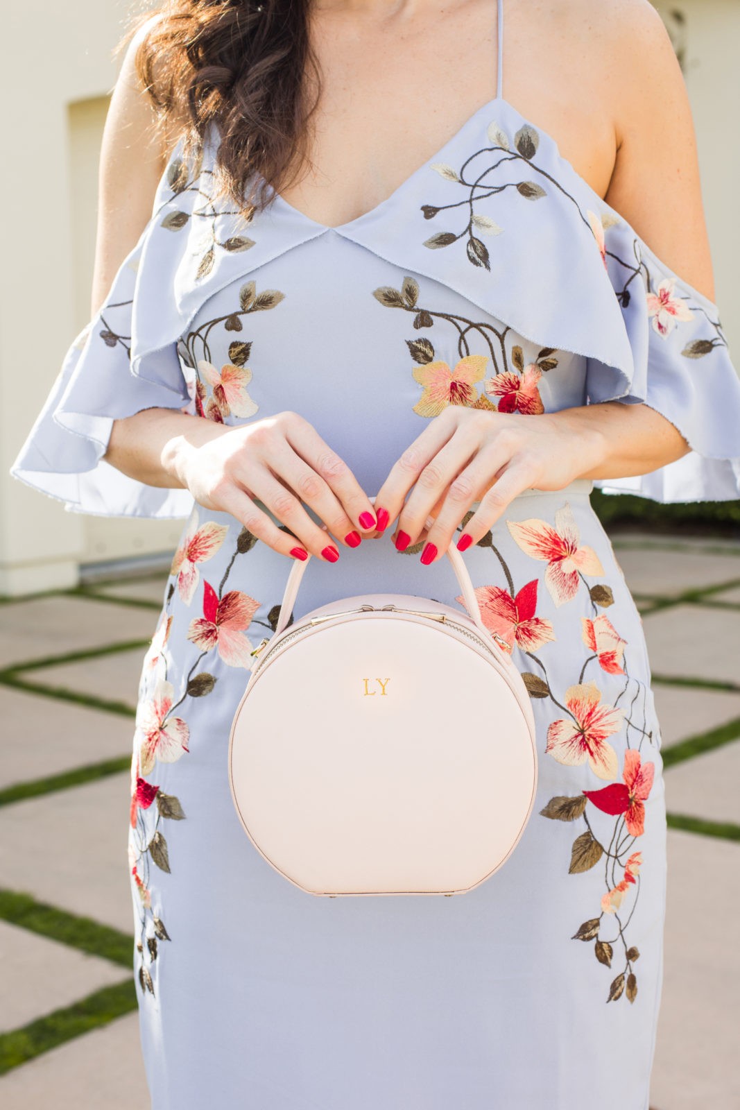 Spring Wedding Guest Dresses featured by top US fashion blogger Laura Lily; Image of a woman wearing an Asos dress, Asos Veil, Charles by Charles David, The Edit personalized handbag and J.Crew earrings.