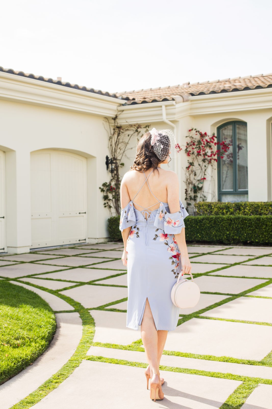 Spring Wedding Guest Dresses featured by top US fashion blogger Laura Lily; Image of a woman wearing an Asos dress, Asos Veil, Charles by Charles David, The Edit personalized handbag and J.Crew earrings.