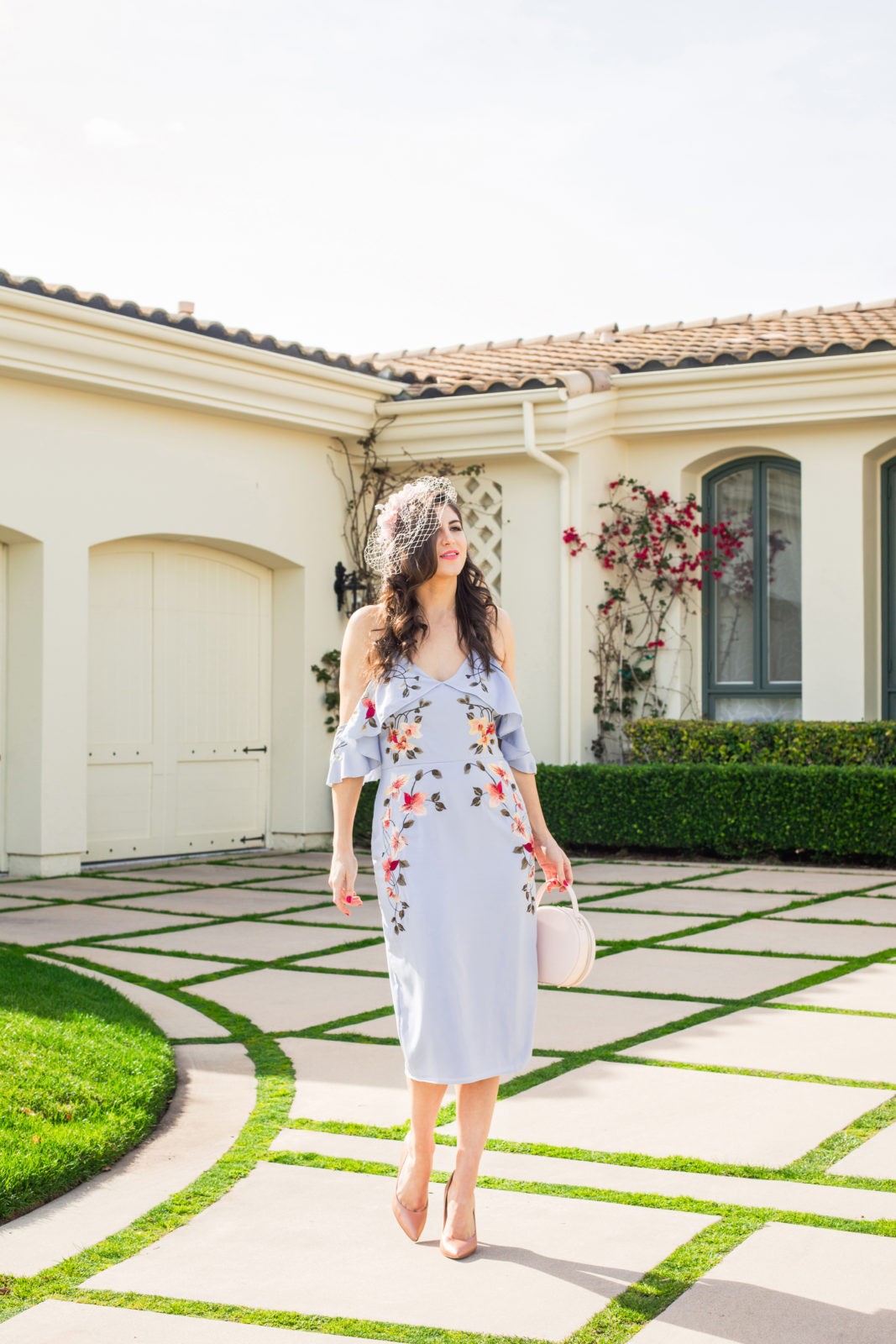 Spring Wedding Guest Dresses featured by top US fashion blogger Laura Lily; Image of a woman wearing an Asos dress, Asos Veil, Charles by Charles David, The Edit personalized handbag and J.Crew earrings.
