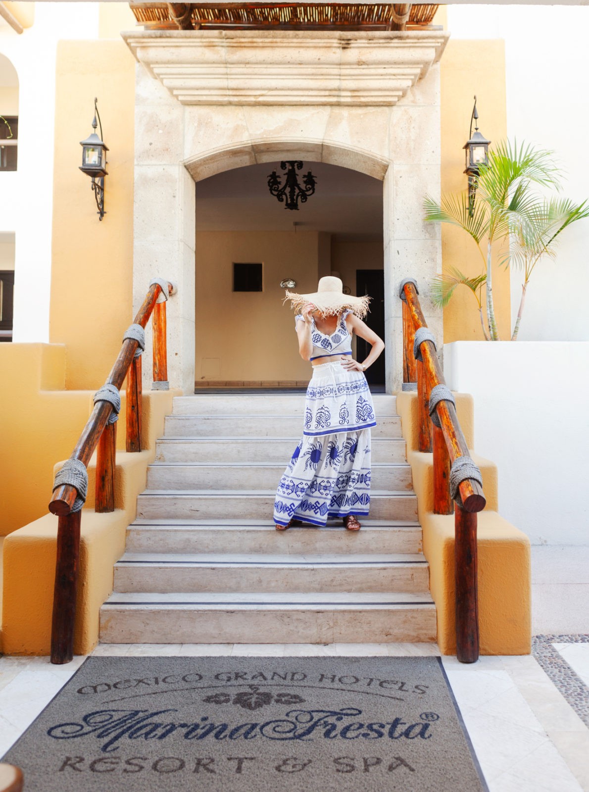 Hacienda Encantada Resort featured by top US travel blogger Laura Lily; Image of a woman wearing a blue and white two-piece dress.