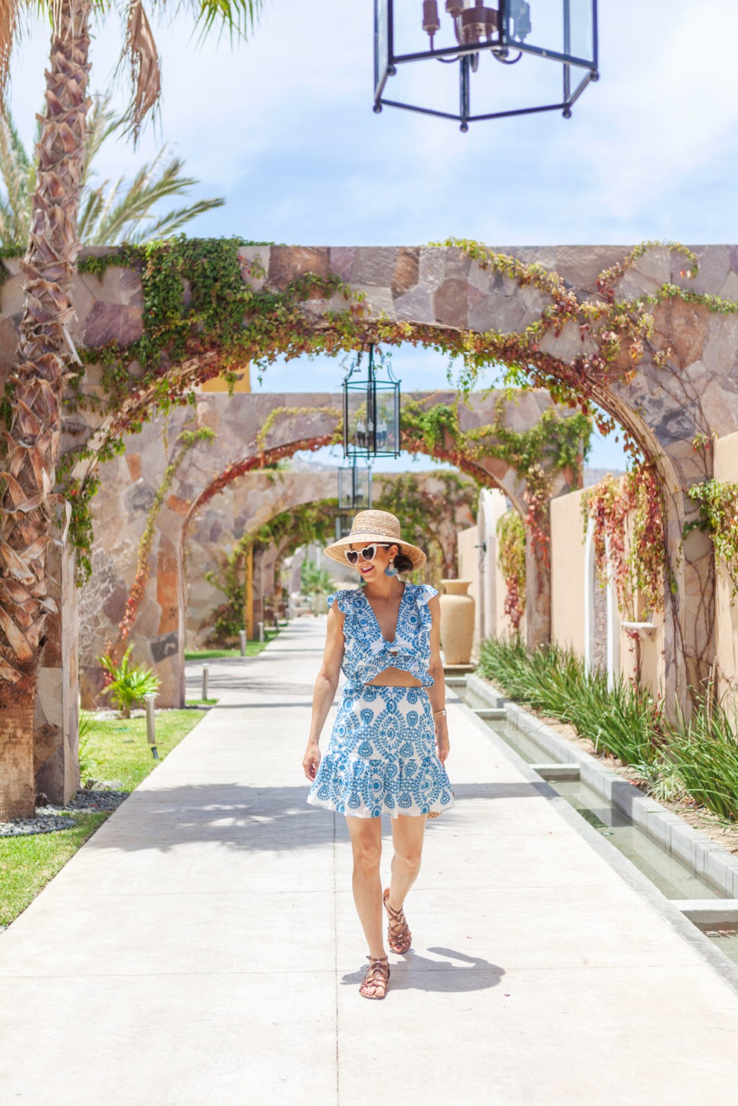 Resort Wear featured by top US fashion blogger Laura Lily; Image of a woman wearing a blue and white dress.