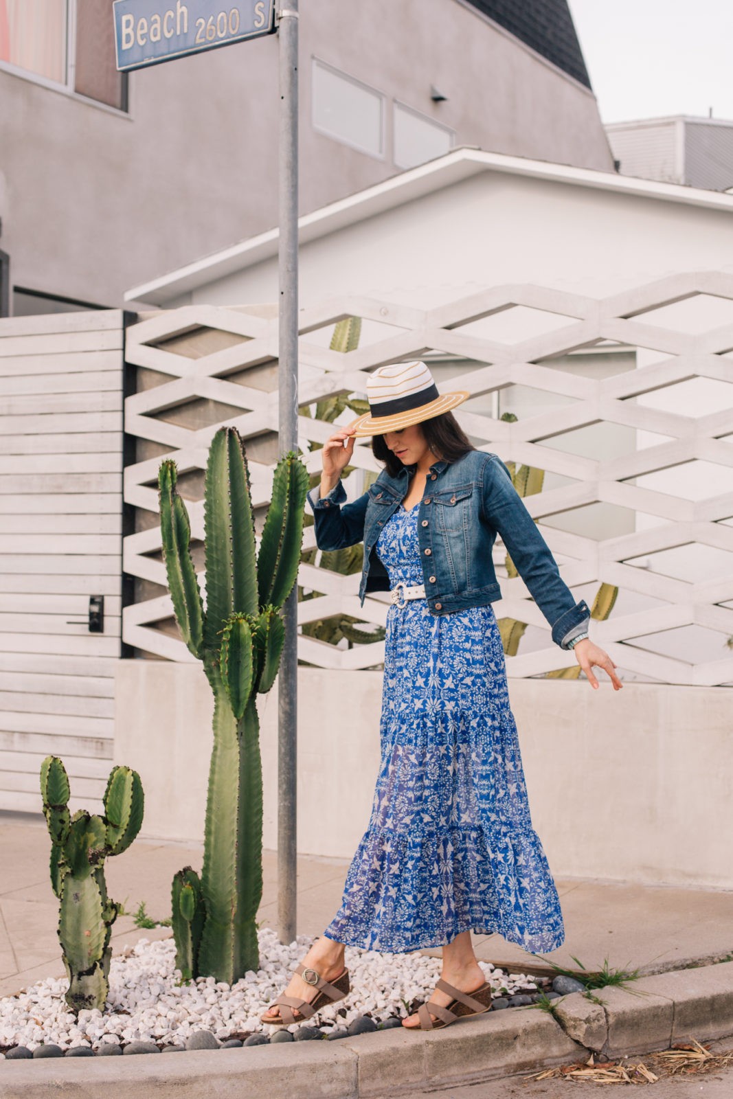 Dansko Sandals, summer essentials, styled by top US fashion blogger, Laura Lily: image of a woman wearing a floral maxi dress, denim jacket, Panama straw hat and Dansko sandals