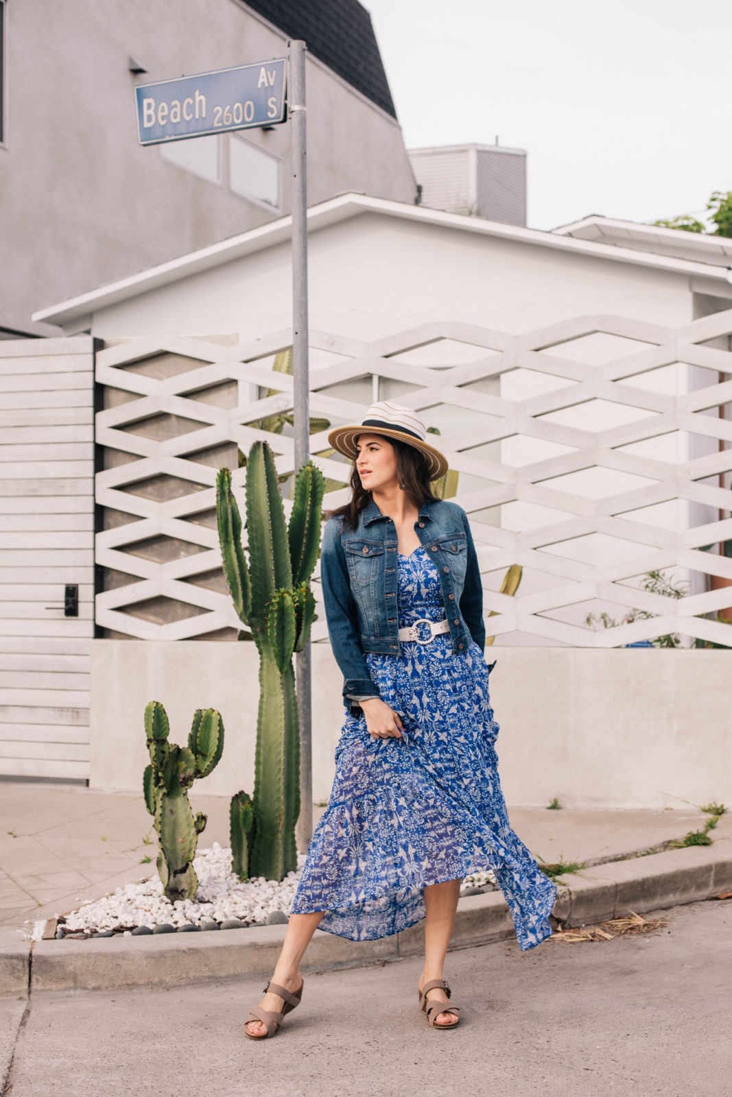 Dansko Sandals, summer essentials, styled by top US fashion blogger, Laura Lily: image of a woman wearing a floral maxi dress, denim jacket, Panama straw hat and Dansko sandals