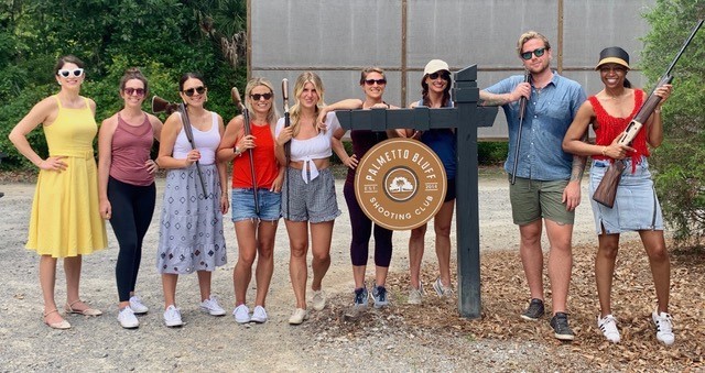 Montage Palmetto Bluff Resort Review by Luxury Travel Blogger Laura Lily: image of a group of people standing behind the Palmetto Bluff Shooting Club sign.