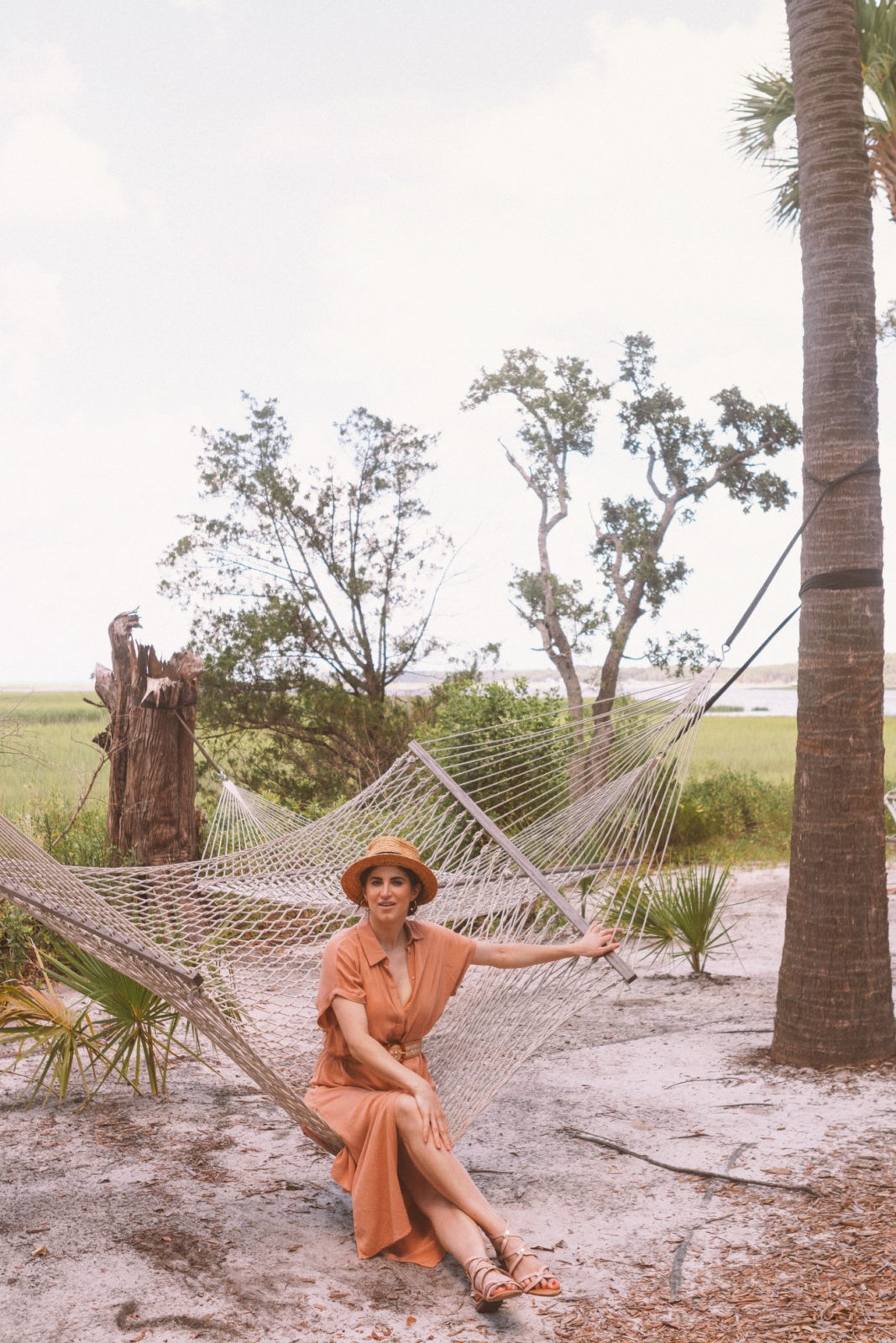 Montage Palmetto Bluff Resort Review by Luxury Travel Blogger Laura Lily: image of a woman sitting outside in a hammock.