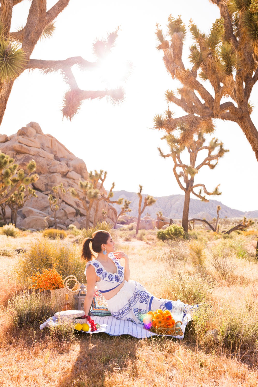 A Moroccan Picnic in the Desert featured by top US life and style blogger, Laura Lily: image of a woman wearing a Red Dress Boutique two piece set, BaubleBar Fringe statement earrings, and heat shape sunglasses
