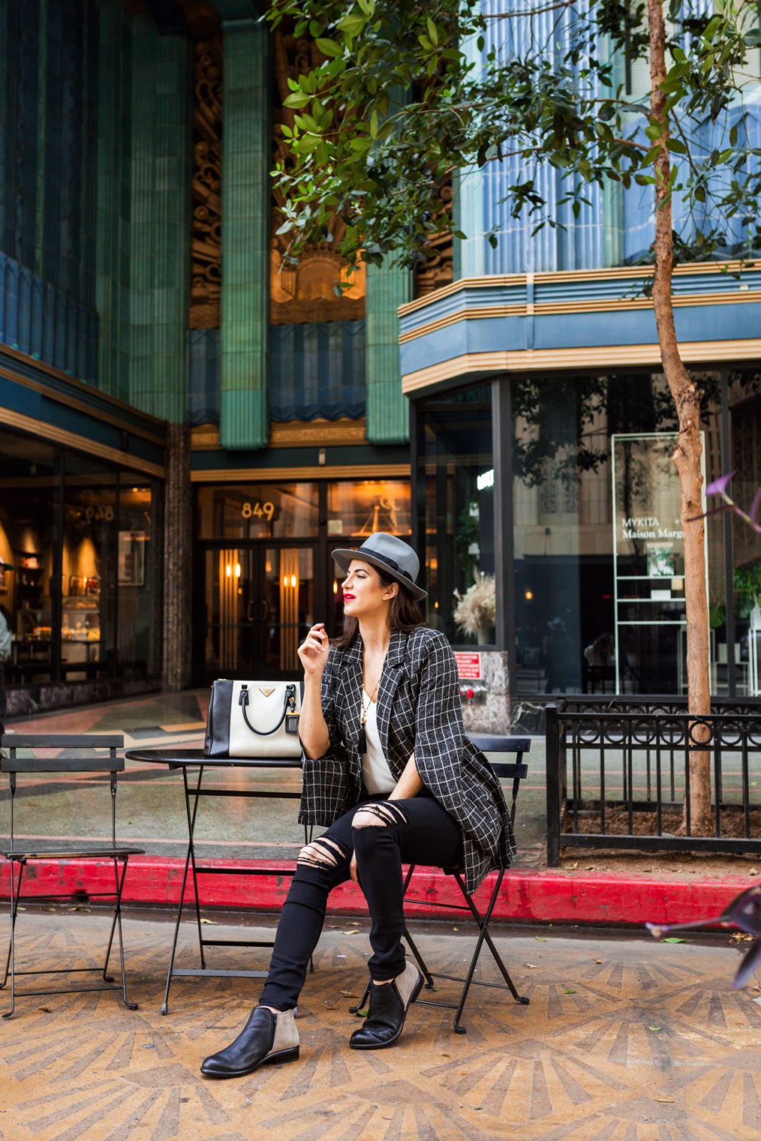 Fall Outfit Ideas by Fashion Blogger Laura Lily, Shein split sleeve blazer, Zappos Naot Helm Bootie, Eastern Building DTLA, | My Everyday Fall Look in the City by popular Los Angeles fashion blogger, Laura Lilly: image of a woman in front of an art deco building and wearing SheIn SHEIN Notch Collar Split Sleeve Double Breasted Grid Blazer, Zappos Naot Helm boot, and Express jeans. 