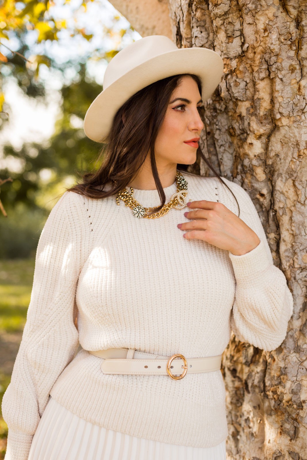 How to Elevate Your Style in Your 30's by Los Angeles Blogger Laura Lily, All white outfit | How to Elevate Your Style in Your 30's by Los Angeles Blogger Laura Lily, All white outfit | How to Elevate Your Style in Your 30's by popular Los Angeles fashion blogger, Laura Lily: image of a woman wearing a Target Women's Relaxed Fit High-Rise Pleated Skirt, Amazon CARDANRO Women's Genuine Leather Jeans Dress Belt with Metal Buckle, H&M sweater, white fedora, and Sam Edelman boots.