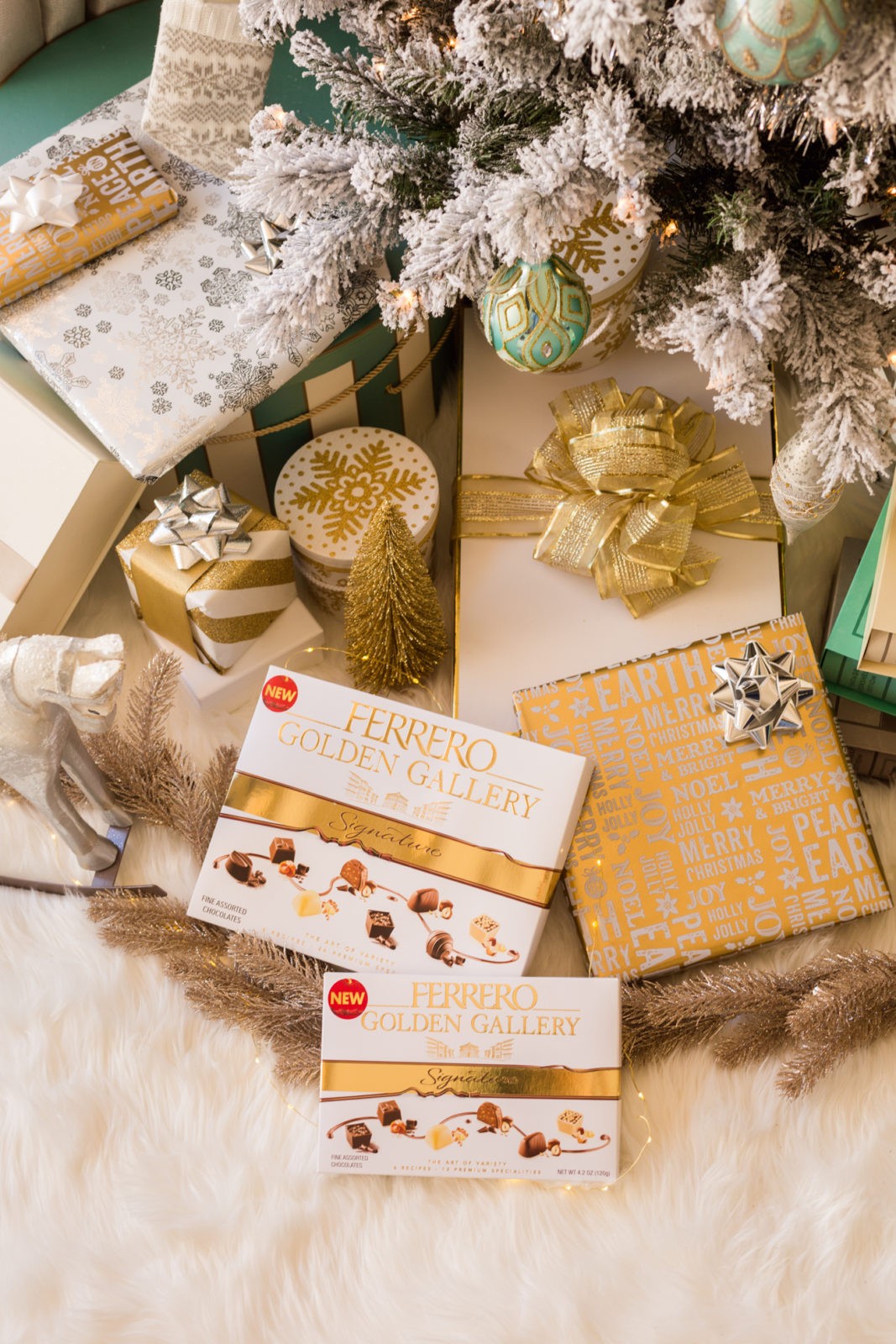 The Perfect Gift for Everyone, Ferrero Golden Gallery Signature Chocolates by Lifestyle Blogger Laura Lily | Ferrero Golden Gallery: The Perfect Holiday Gift for Everyone by popular Los Angeles life and style blogger, Laura Lily: image of wrapped presents and a couple boxes of Ferrero Golden Gallery chocolates under a Christmas tree.