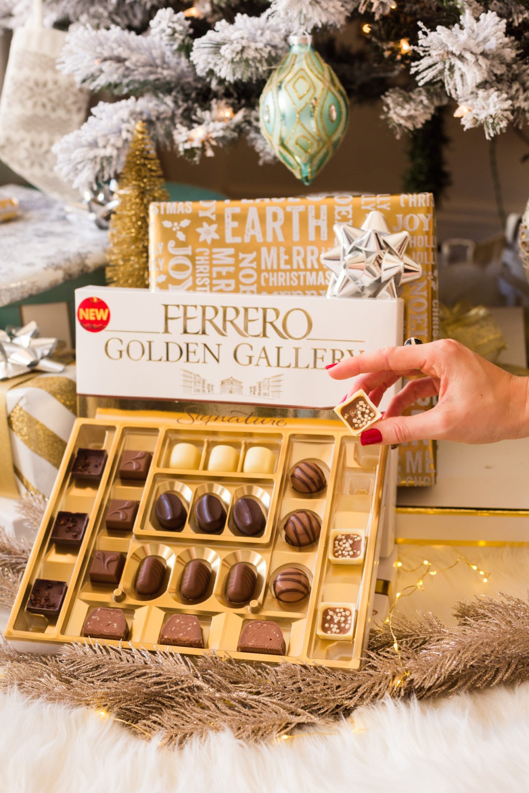 The Perfect Gift for Everyone, Ferrero Golden Gallery Signature Chocolates by Lifestyle Blogger Laura Lily | Ferrero Golden Gallery: The Perfect Holiday Gift for Everyone by popular Los Angeles life and style blogger, Laura Lily: image of wrapped presents and an open box of Ferrero Golden Gallery chocolates under a Christmas tree.
