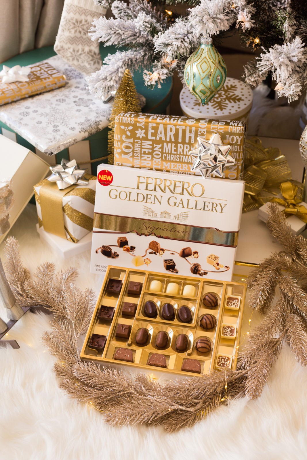 The Perfect Gift for Everyone, Ferrero Golden Gallery Signature Chocolates by Lifestyle Blogger Laura Lily | Ferrero Golden Gallery: The Perfect Holiday Gift for Everyone by popular Los Angeles life and style blogger, Laura Lily: image of wrapped presents and an open box of Ferrero Golden Gallery chocolates under a Christmas tree.