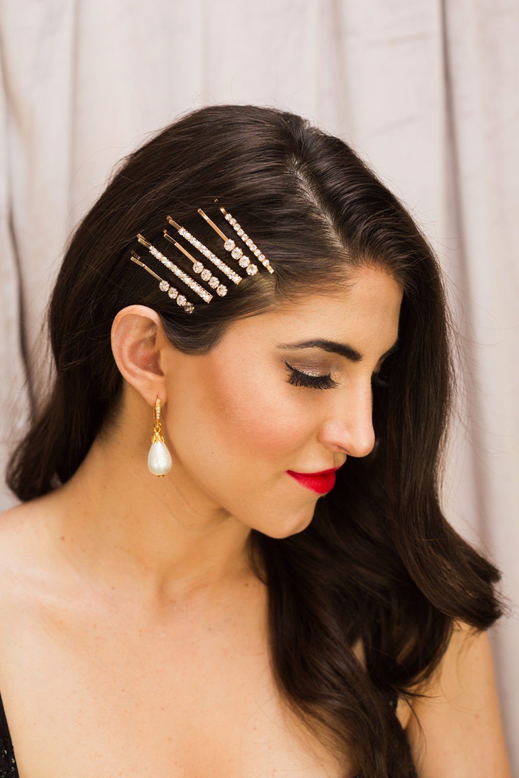 Classic Holiday Makeup Look by Beauty Blogger Laura Lily | Classic Holiday Makeup Tutorial by popular Los Angeles beauty blogger, Laura Lily: image of a woman wearing Nordstrom Oscar de la Renta OSCAR DE LA RENTA Imitation Pearl Drop Earrings, Main, color, PEARL Imitation Pearl Drop Earrings, Nordstrom Bronx and Banco Mademoiselle Noir Sequin Cocktail Dress, Nordstrom Chanel ROUGE ALLURE INK MATTE LIQUID LIP COLOUR, Nordstrom BP. Set of 6 Imitation Pearl & Crystal Hair Clips, Amazon Eylure Nikki Phillippi Feather light Feel Eyelashes, and holding a Target Estee & Lilly Crystal Mesh Pouch Frame Clutch.