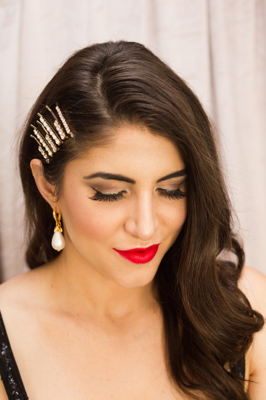 Classic Holiday Makeup Look by Beauty Blogger Laura Lily | Classic Holiday Makeup Tutorial by popular Los Angeles beauty blogger, Laura Lily: image of a woman wearing Nordstrom Oscar de la Renta OSCAR DE LA RENTA Imitation Pearl Drop Earrings, Main, color, PEARL Imitation Pearl Drop Earrings, Nordstrom Bronx and Banco Mademoiselle Noir Sequin Cocktail Dress, Nordstrom Chanel ROUGE ALLURE INK MATTE LIQUID LIP COLOUR, Nordstrom BP. Set of 6 Imitation Pearl & Crystal Hair Clips, Amazon Eylure Nikki Phillippi Feather light Feel Eyelashes, and holding a Target Estee & Lilly Crystal Mesh Pouch Frame Clutch.