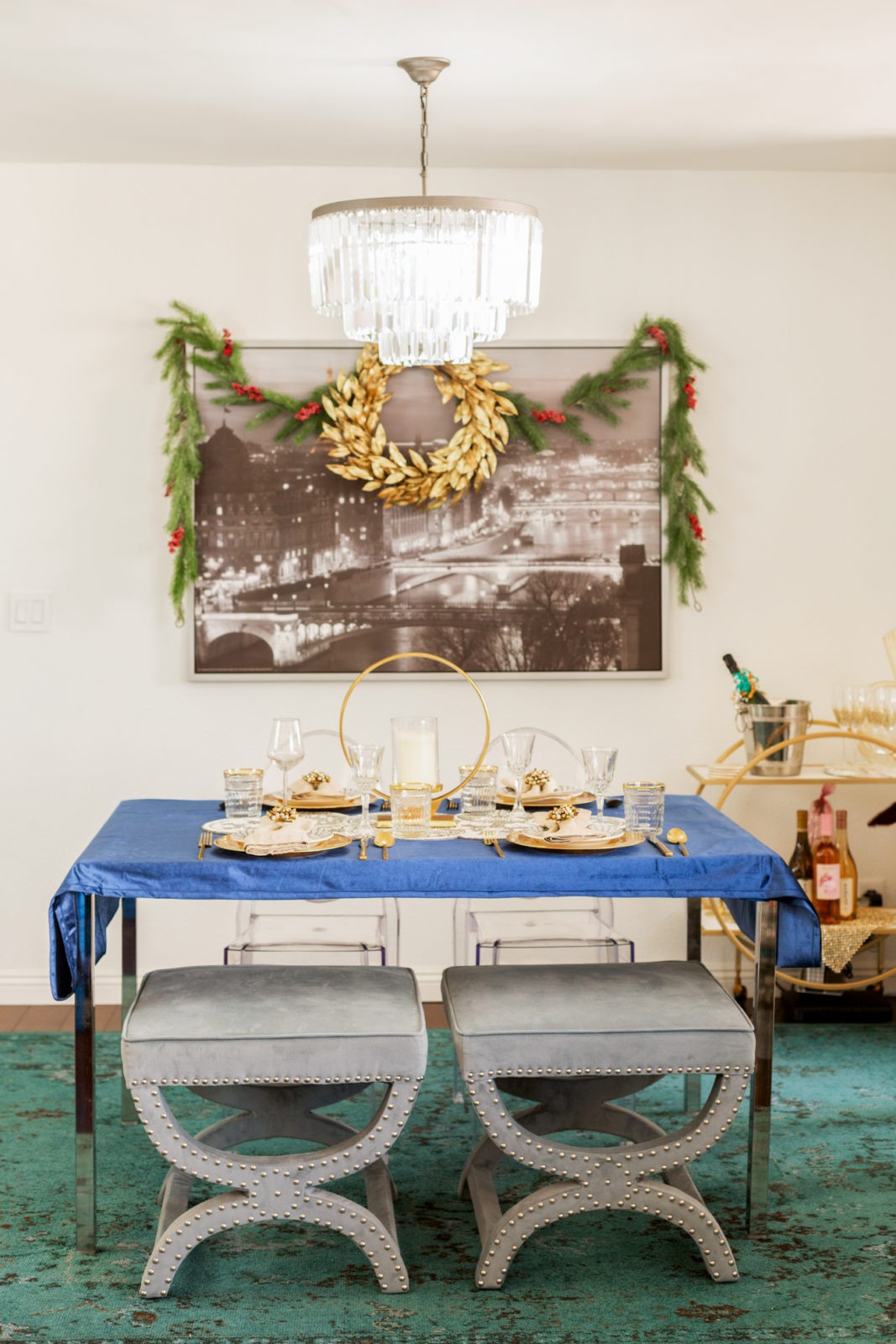 Holiday Home Decor 2019 by popular Los Angeles life and style blogger, Laura Lily: image of a dining room with overstock stools and chandelier, RugsUSA rug, and Z Gallerie bar cart.